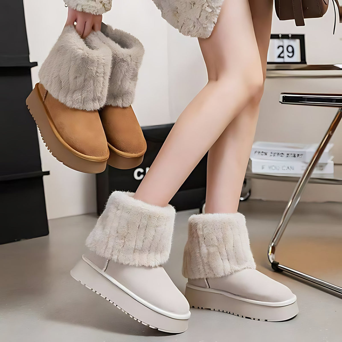 Fleece-lined snow boots in cream and khaki — one pair worn, one carried, both with fluffy fold-over faux-fur cuffs