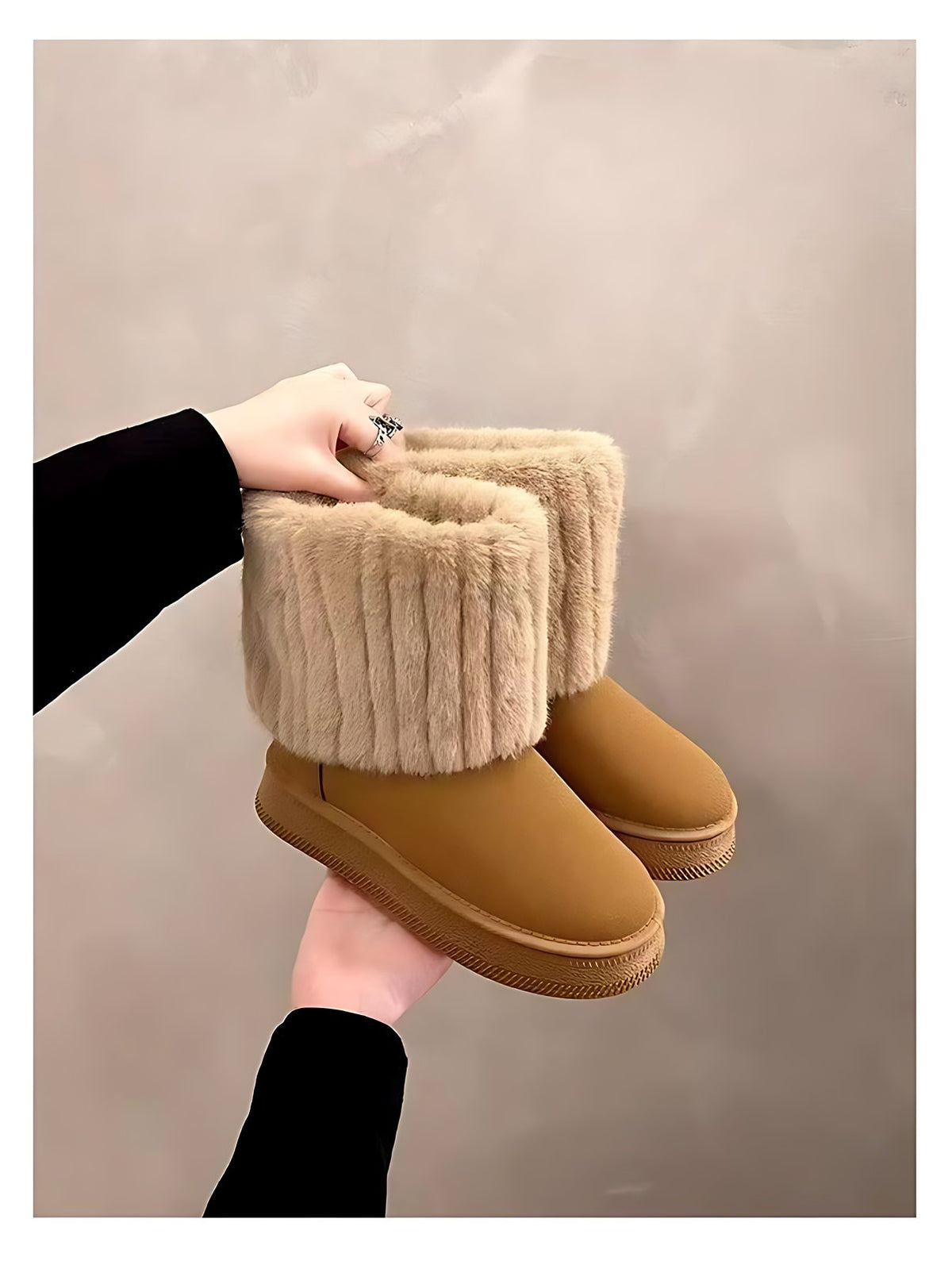 Close-up of a khaki winter snow boot held in hand — plush faux-fur cuff, rounded toe and thick platform sole